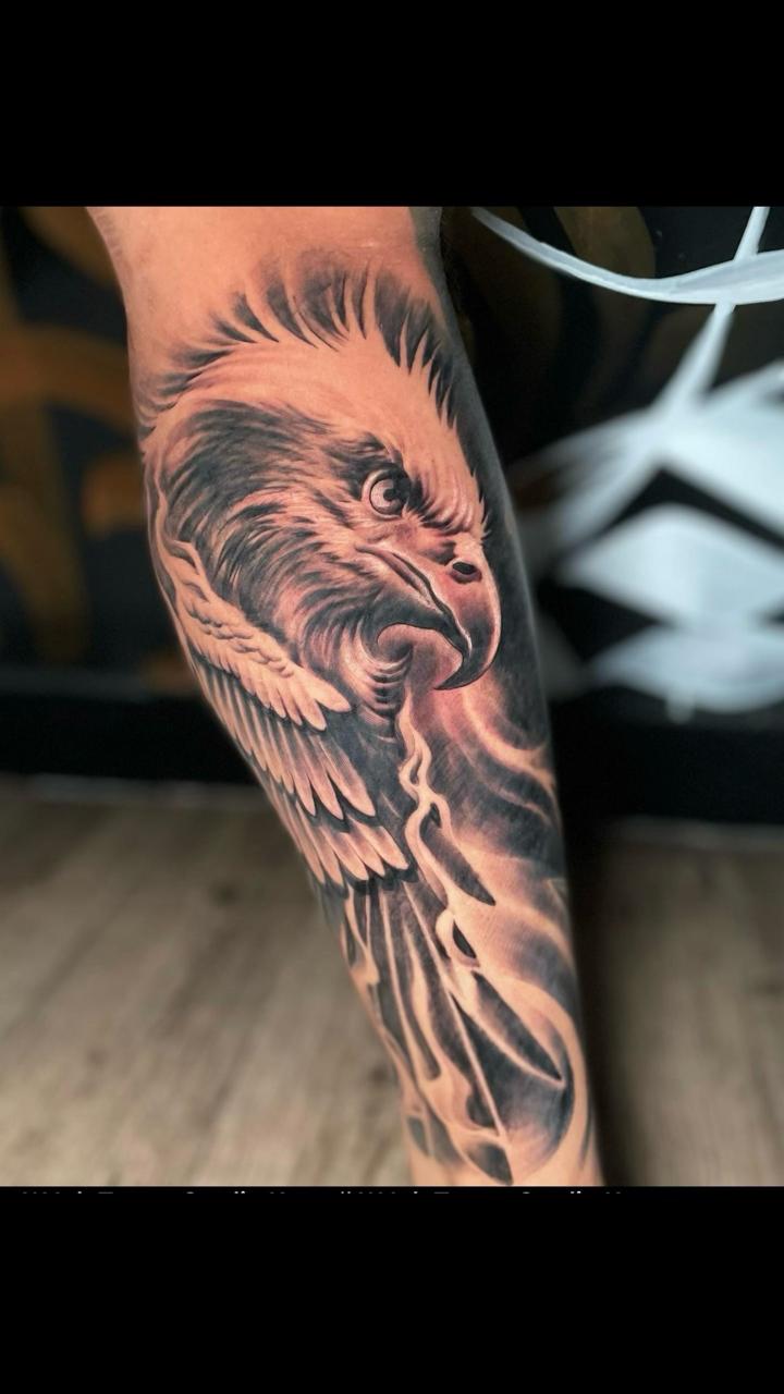 Black and grey realism eagle leg tattoo