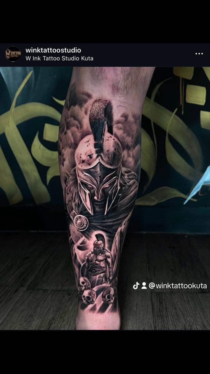 Black and grey realism spartan leg tattoo