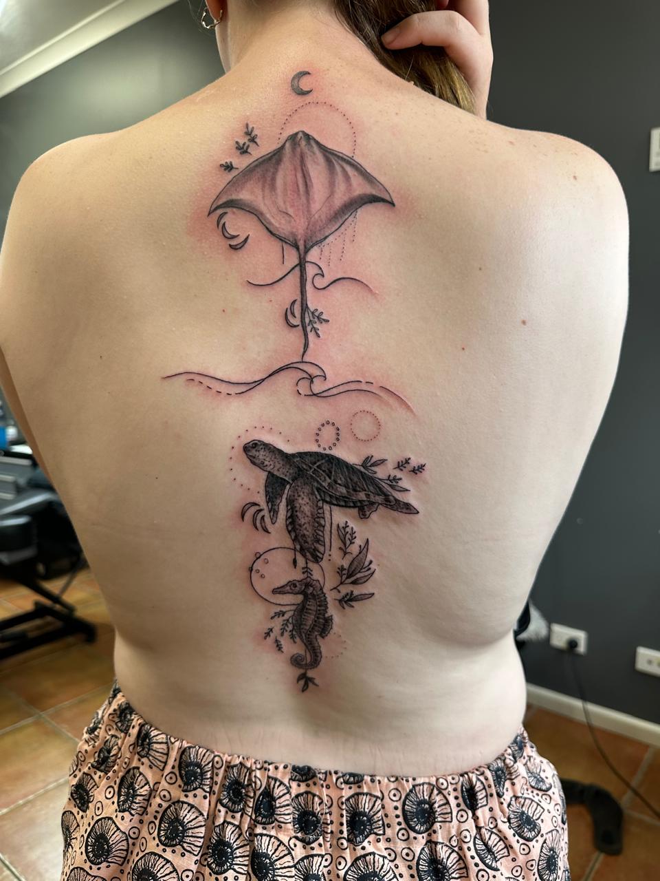 Fine line ocean life spine tattoo